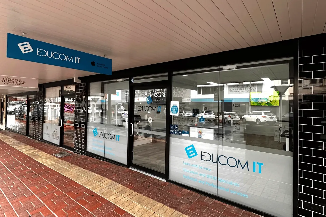 The EduCom IT store on Dean Street, Albury — the shopfront sign and window graphics above the glazed frontage, with the service counter visible inside.