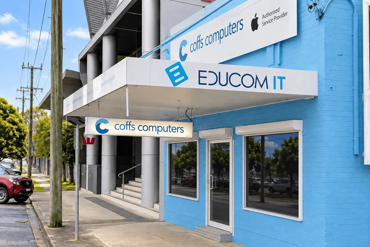 The Coffs Computers store on Harbour Drive, Coffs Harbour — EduCom IT and Coffs Computers signage above the blue-brick shopfront.