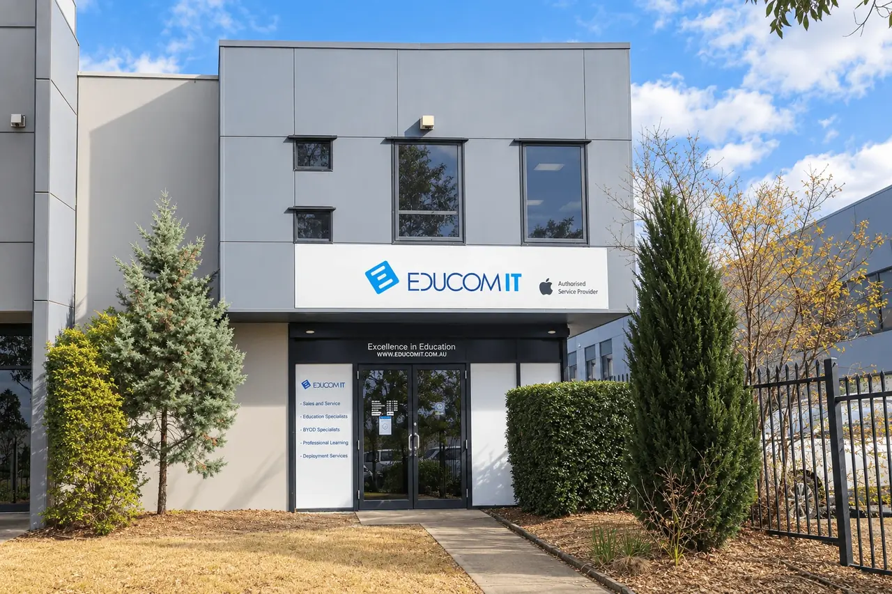 The EduCom IT office on Hartley Road, Smeaton Grange — the EduCom IT sign above the entrance to the two-storey building, with landscaped garden either side of the path.